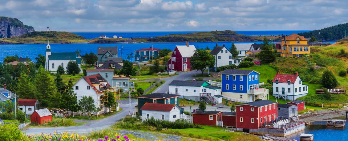 Colourful houses dotting the shoreline of Trinity Bay