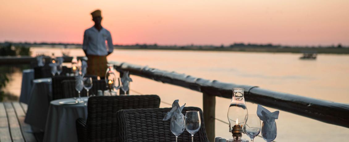 Outdoor dining on the deck at Chobe Game Lodge overlooking the Chobe River